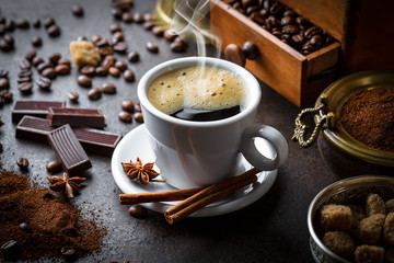 Black coffee in a cup on old background