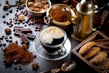 Black coffee in a cup on old background