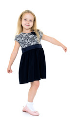 Little girl in a dress developing in the wind.