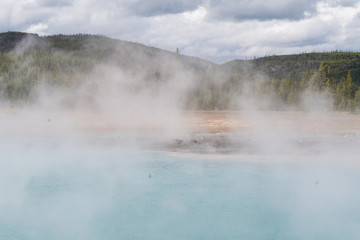 Yellowstone national park landscape. Geothermal activity, hot thermal springs with boiling water and fumes at Yellowstone National Park, USA