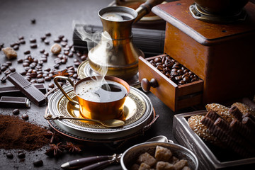 Black coffee in a cup on old background