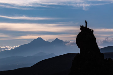 Silhouette of a rock peak with a person on the top