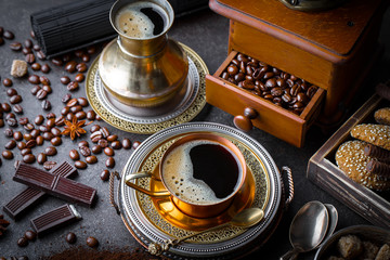 Black coffee in a cup on old background