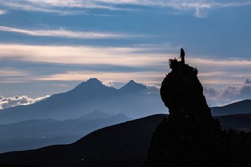 Silhouette of a rock peak with a person on the top