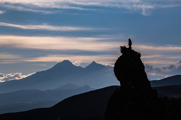 Silhouette of a rock peak with a person on the top