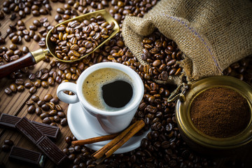 Black coffee in a cup on old background