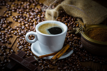 Black coffee in a cup on old background