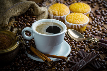 Black coffee in a cup on old background