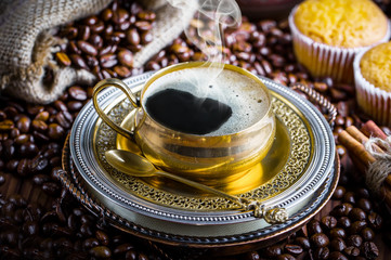 Black coffee in a cup on old background