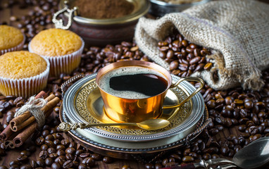 Black coffee in a cup on old background