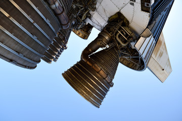  Several large powerful liquid fueled rocket engines against a clear blue sky.
