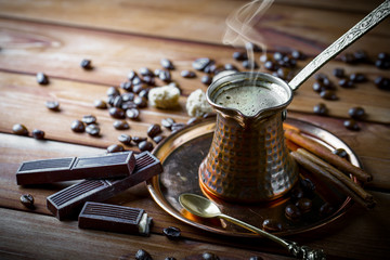 Black coffee in a cup on old background