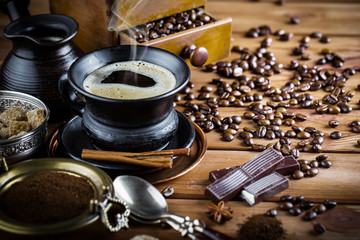 Black coffee in a cup on old background