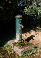 Water column in the street with concrete base and flowing water