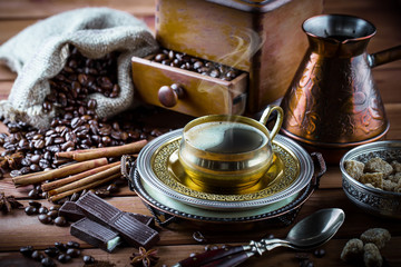 Black coffee in a cup on old background