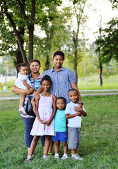 Fototapeta premium big happy African-American family in the background of the Park on a Sunny day