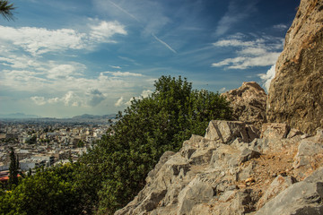 south dry rocks mountains and green plants on blue colorful sky background, good place for hiking, Greece, Thermopylae 