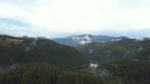 Wide Overhead Aerial Drone Establishing Shot Revealing a River and  Valley Fog