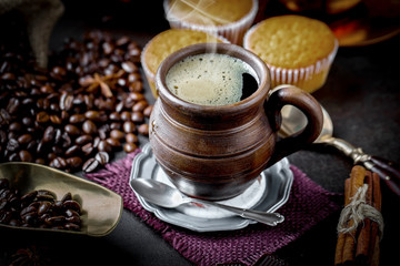 Black coffee in a cup on old background