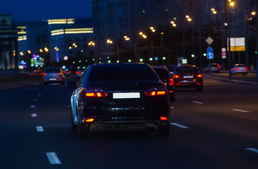 Fototapeta na wymiar Car traffic at night on the avenue