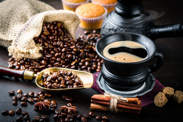 Black coffee in a cup on old background