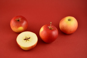 Red fresh apples stock images. Apples on a red background. Sliced apple. Juicy apples stock images