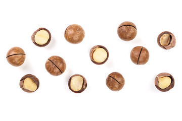 Shelled and unshelled macadamia nuts isolated on white background with copy space for your text. Top view. Flat lay pattern