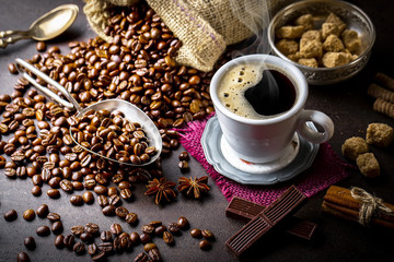 Black coffee in a cup on old background