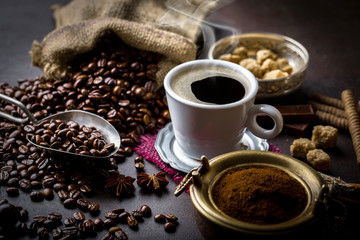 Black coffee in a composition with kitchen accessories