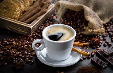 Black coffee in a cup on old background