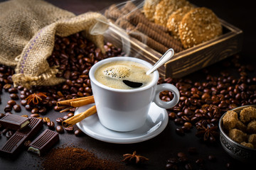 Black coffee in a cup on old background