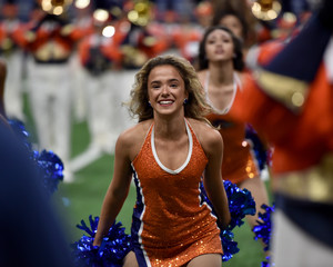 Young college cheerleader performing at a college football game © Joe