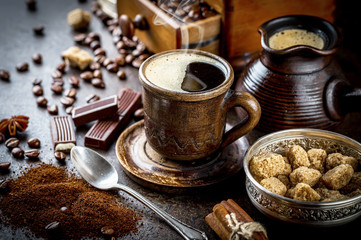 Black coffee in a composition with kitchen accessories