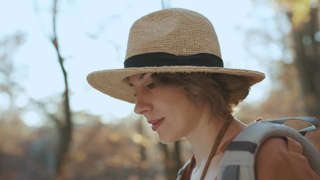 Close up Attractive young woman in stylish hat and a tourist map in her hands looking around