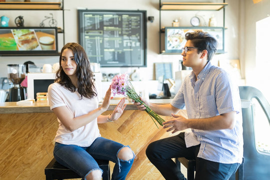 Man Giving Flowers To A Cranky Woman