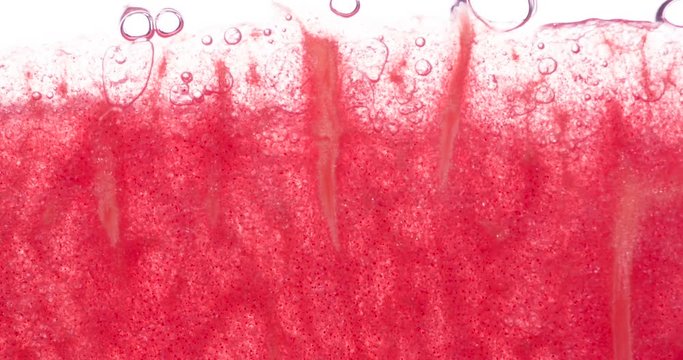 Squeezing Juicy Watermelon Pulp. Slices and slices of watermelon are compressed and crushed close-up on a bright white background, creating a juicy splash of pulp and juice. Shooting at 120 fps