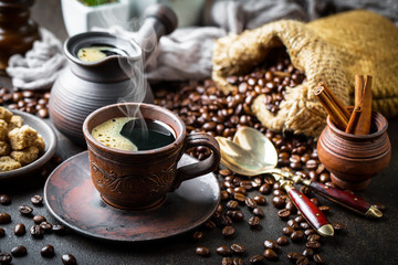 Black coffee in a cup on old background