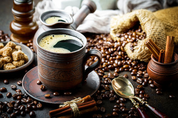 Black coffee in a cup on old background