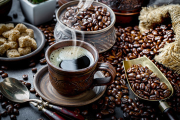 Black coffee in a cup on old background