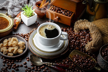Black coffee in a cup on old background