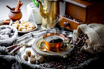 Black coffee in a cup on old background