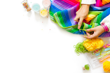 Colorful, bright, iridescent plaid, blanket. Crochet. Knitting yarn in a basket