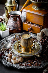 Black coffee in a cup on old background