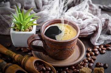 Black coffee in a cup on old background