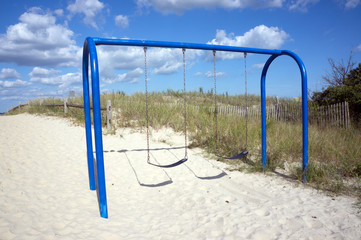 Empty Swings On A Beach