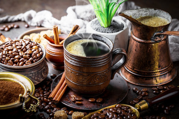 Black coffee in a cup on old background