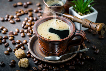 Black coffee in a cup on old background