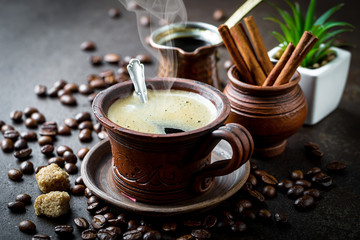 Black coffee in a cup on old background