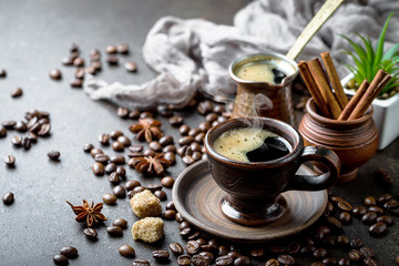 Black coffee in a cup on old background