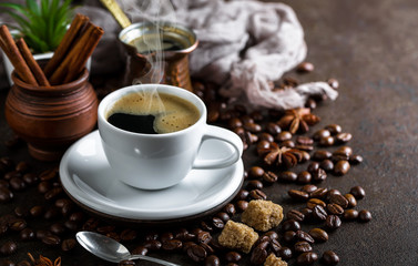 Black coffee in a cup on old background